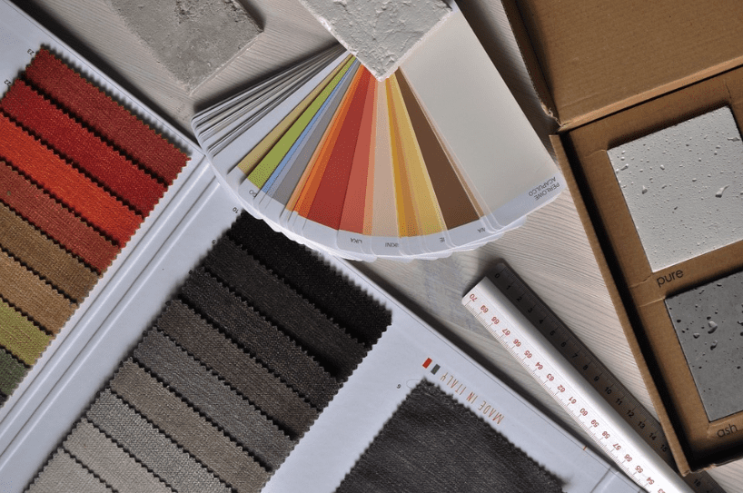 Selection of color swatches and material samples spread out for interior design planning.