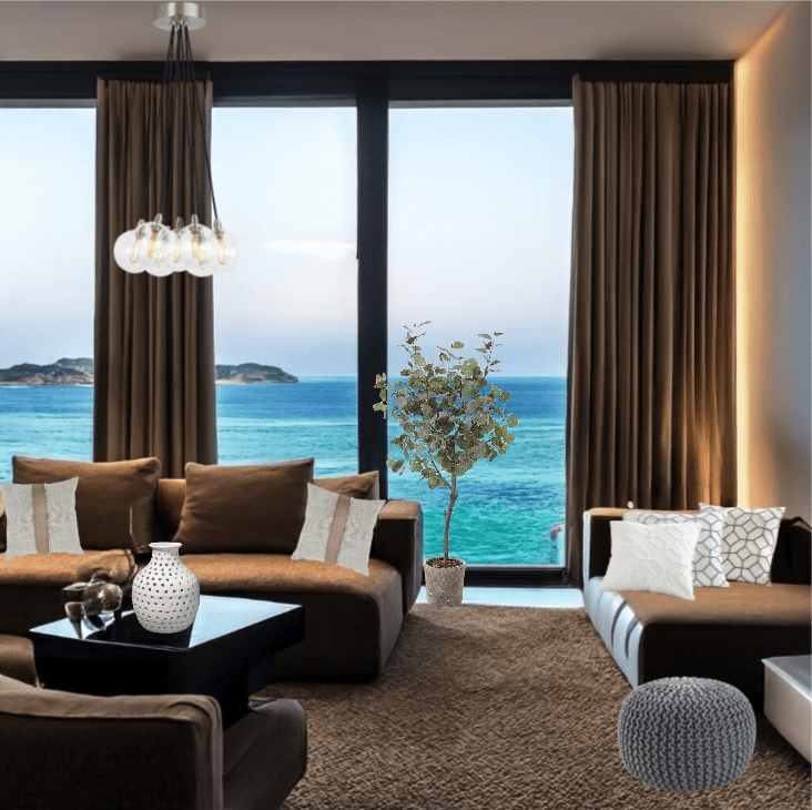 Modern living room with ocean view through large windows.